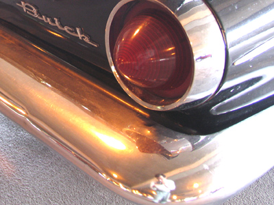The shot of this Buick`s tail fins didn`t look good, but I got a nice reflection of Mini Me in the bumper.
