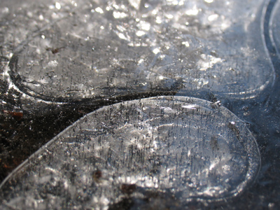 Touched by the sun, ice becomes a glistening film.