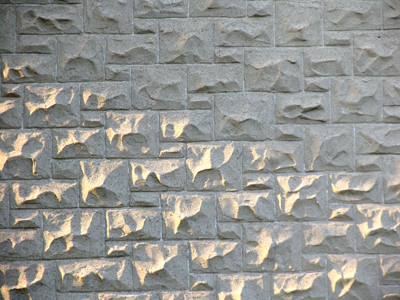 A very large stone wall at sunrise.