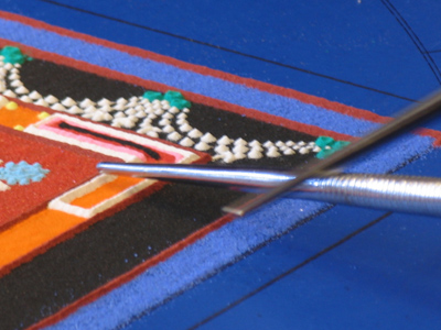 And through extraordinary skill and patience, the sand becomes a sculpture.