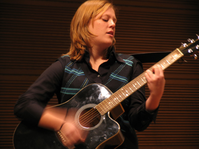 The guitar isn`t her primary instrument, but it`s hard to play trombone and sing at the same time.