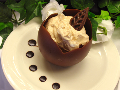 An edible chocolate cup filled with cinnamon ice cream (actually shortening mixed with coffee grounds).