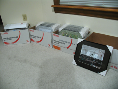 Photos on the floor:  there must be an exhibition coming.  Notice these are in real frames, for a real gallery.