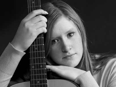 A last-minute volunteer for my portrait class assignment.  Don`t tell anybody, but she doesn`t really play the guitar.