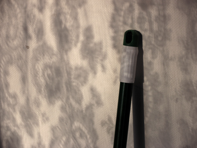 Broom handle and lace curtain shadow.