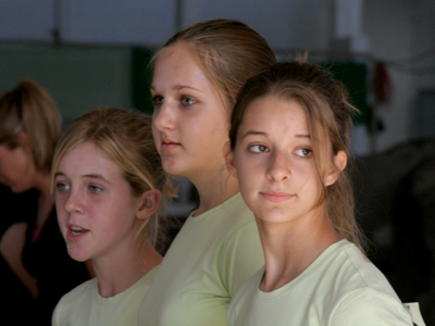 Contestants in the horse grooming contest stand shoulder to shoulder, ready to compete head to head.