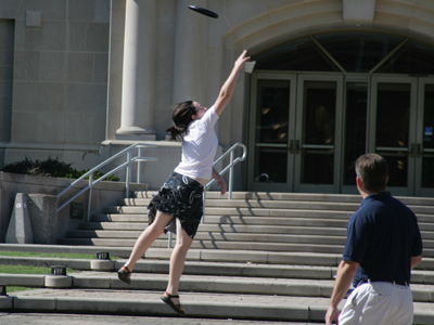 She missed the Frisbee, so the passer-by had to catch it in self-defense.