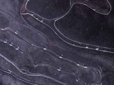 Beneath the ice, canals are made by traveling air bubbles.