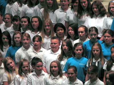 A choir with hundreds of children is singing . . . 