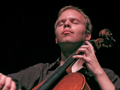 Tiny spots of moisture appear on the fingerboard of a cello, but evaporate as quickly as the sound diminishes.