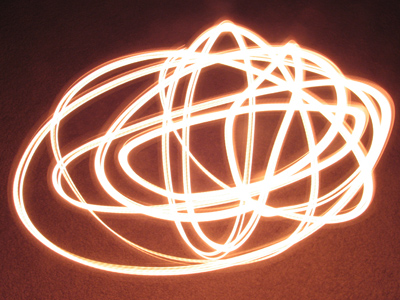 Christmas candle swinging from its electrical cord.