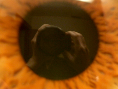 My hands and camera, reflected in my eye.  Strictly a boredom shot.