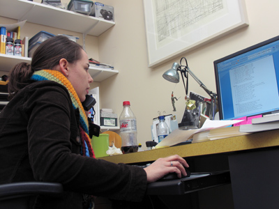 A frugal person works late on a Friday evening.