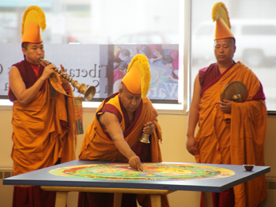 With much ringing of bells, blowing of horns and chanting of prayers, the beautifully designed and skillfully created mandala is swept up into a mound of colored sand.