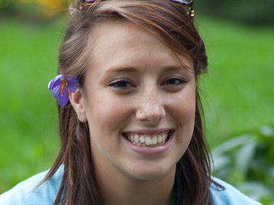 I came across this flower-bedecked maiden out in the garden taking pictures with a FILM camera.