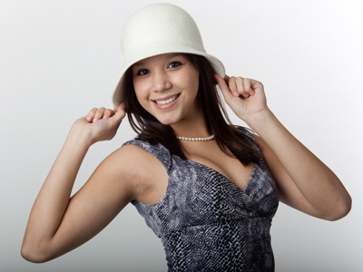 A borrowed hat and a borrowed dress, but the smile belongs to her.