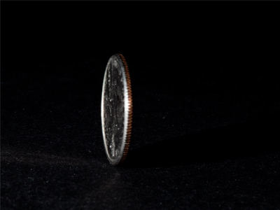 I got out my new remote flash trigger and light stand and started to experiment with some spinning quarters.