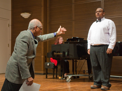 Veteran opera singer encourages freshman music major to sing louder.