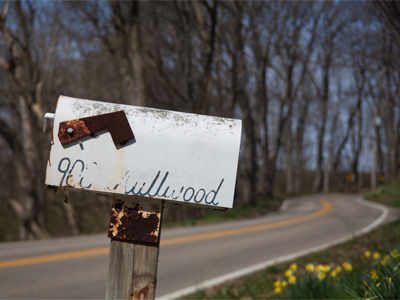 Along this winding road is a unique house that is surrounded by an enormous garden.