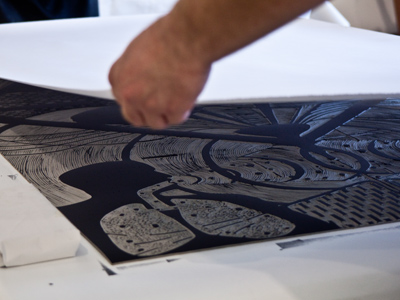 Printmaking with Ryan McCullouh, Step Three:  Lay a piece of paper onto the inked original.
