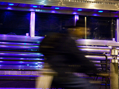 Still sitting inside my car, I was shooting the mysterious purple glow of Club Vex when a dude went by on a bike.