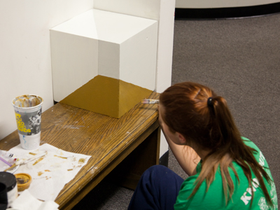 The optical illusion she`s painting didn`t look precisely right to me.  `You have to be shorter,` she explained.