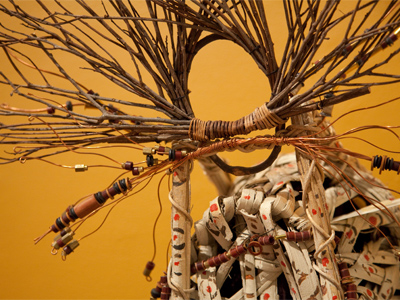 His artwork blends traditional African influences with modern materials and themes.