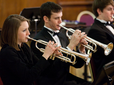 A certain trumpet player arrived for the 3:00pm concert at 2:59:50pm.