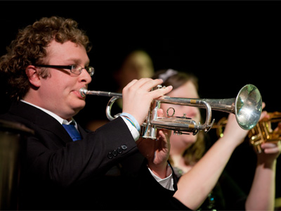 How do you get a trumpeter to play softly?  Take away his horn.
