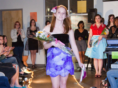 Her dress is made out of coffee filters and black tape.