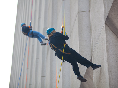 As the `prize` for a charity fundraiser, these people are descending one of the tallest buildings in Dayton.  County commisioner Debbie Lieberman is in the foreground.