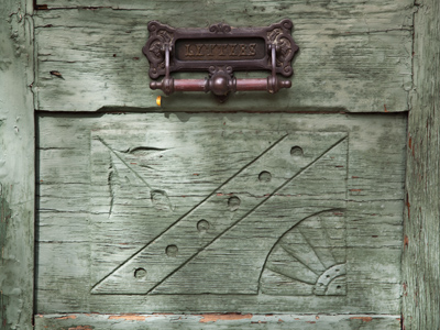 Nice woodwork on this old door, but is it upside down?