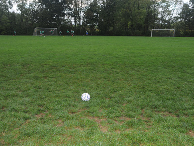 Ah, the glamorous life of a professional photographer:  this morning I got up at 5:15am so I could take pictures of hundreds of little soccer players outside in the rain.
