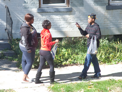 Laughing loudly and taking pictures with a Romney sign.