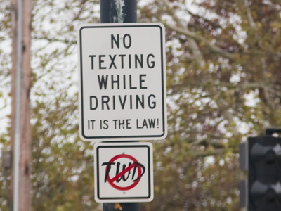 It SHOULD be against the law, since it`s very dangerous.  But they can`t keep me from taking pictures while driving.