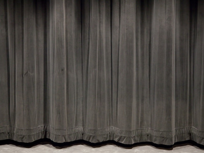 Thirty seconds before the meeting, in full view of everyone, the school board members posed for the photo right here.  I fled the auditorium; they had to stay and face the public.