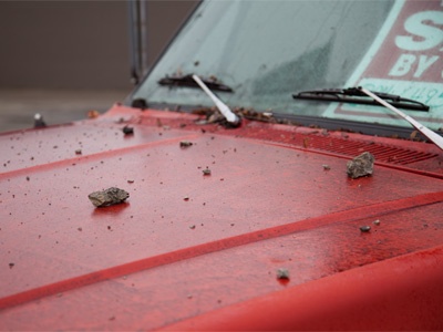 The curb stopped the car, but concrete debris was thrown a long distance . . . 