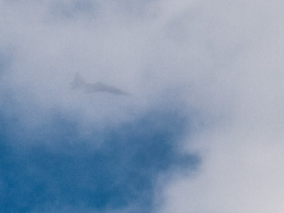 Unfamiliar fighter jet vanishes into clouds.  North Korean?