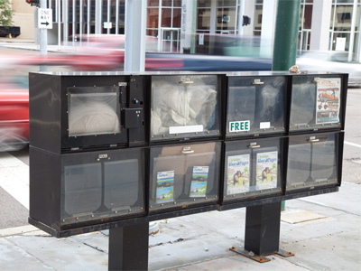 My city:  a pillow and blanket stored in a newspaper box.