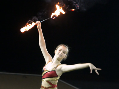 After her pregame performance, she stood there and held that flaming baton while a priest gave what was, under the circumstances, an excessively long prayer.