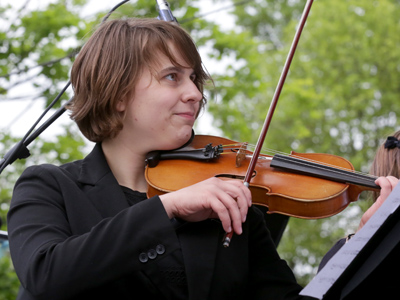 She was the one playing trombone in the previous photo, and also the unicycle hula hoop juggler on May 2 above!