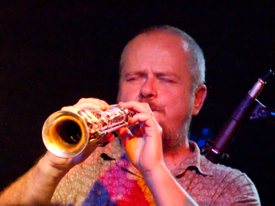 The reed man also plays the guitar.