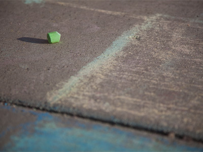 Hundreds of commuters drive by, I kneel on the sidewalk.  My camera only strengthens my aloofness from people.