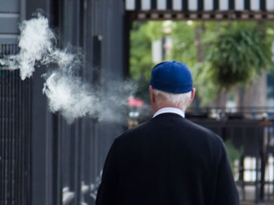 He traveled in a cloud of smelly cigar smoke.