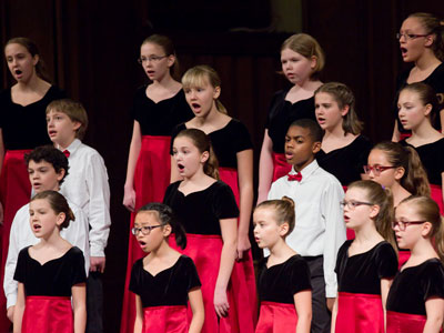 The singers change but not the red dresses and bow ties.