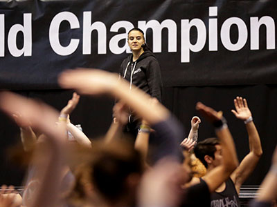 The day after the color guard world championships, a choreographer led a large dance class.