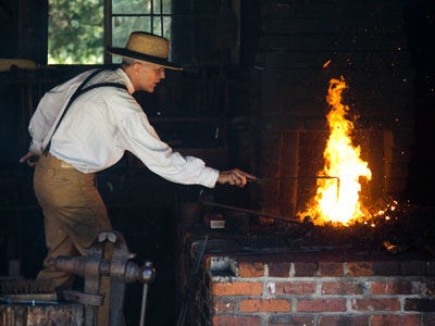 The blacksmith is really fired up about his job.