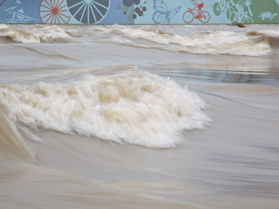 I`m glad the levee keeps the river from flooding the city.  It`s just a bonus that it has nice pictures painted on it.
