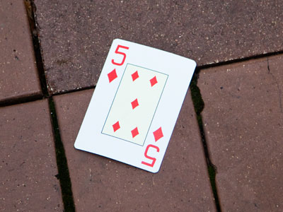 In cartomancy, the five of diamonds symbolizes positive relationships or a solution to a problem.