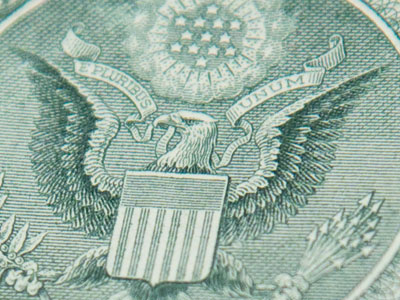 A bald eagle appears on the back of a legitimate $1 bill.  If a bill shows a chicken instead, it is likely a counterfeit.